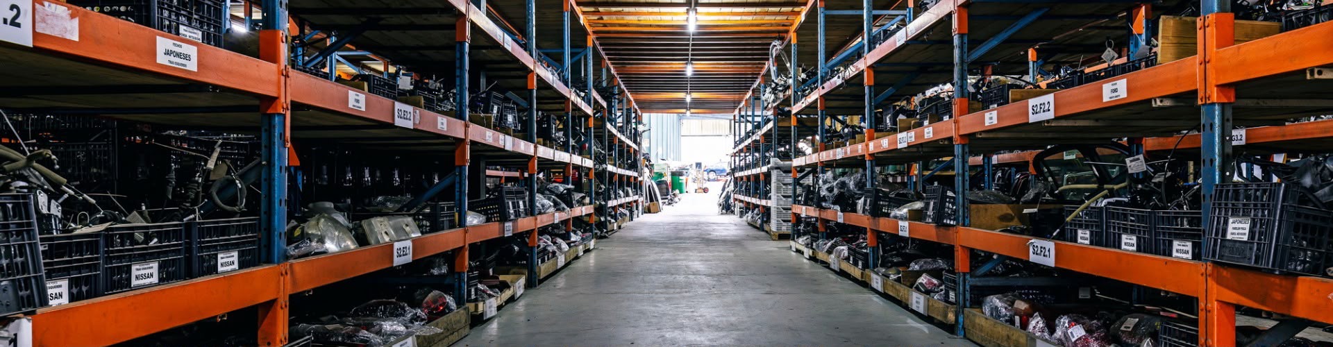 Aisle between warehouse racks of vehicle parts