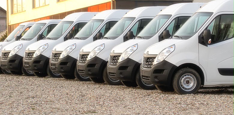 A line of white transport vans